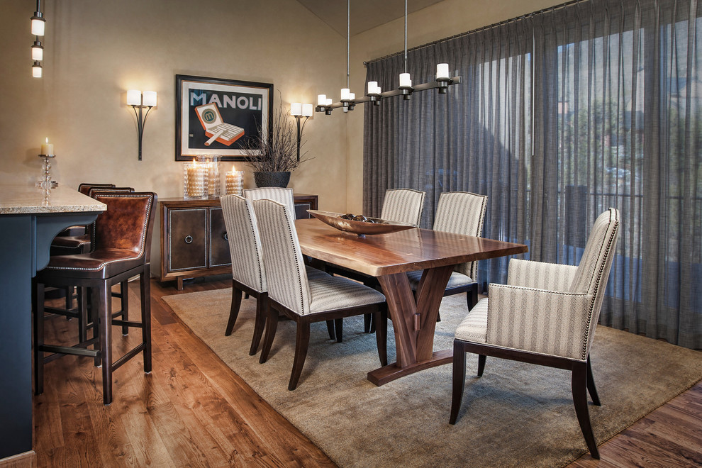 Inspiration for a mid-sized transitional medium tone wood floor and brown floor enclosed dining room remodel in Denver with beige walls and no fireplace