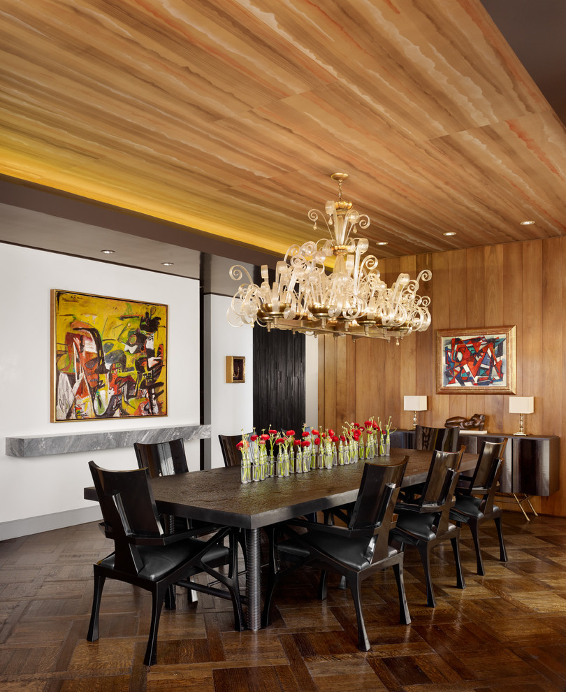 This is an example of a midcentury dining room in Austin with white walls, dark hardwood flooring, no fireplace, brown floors and feature lighting.