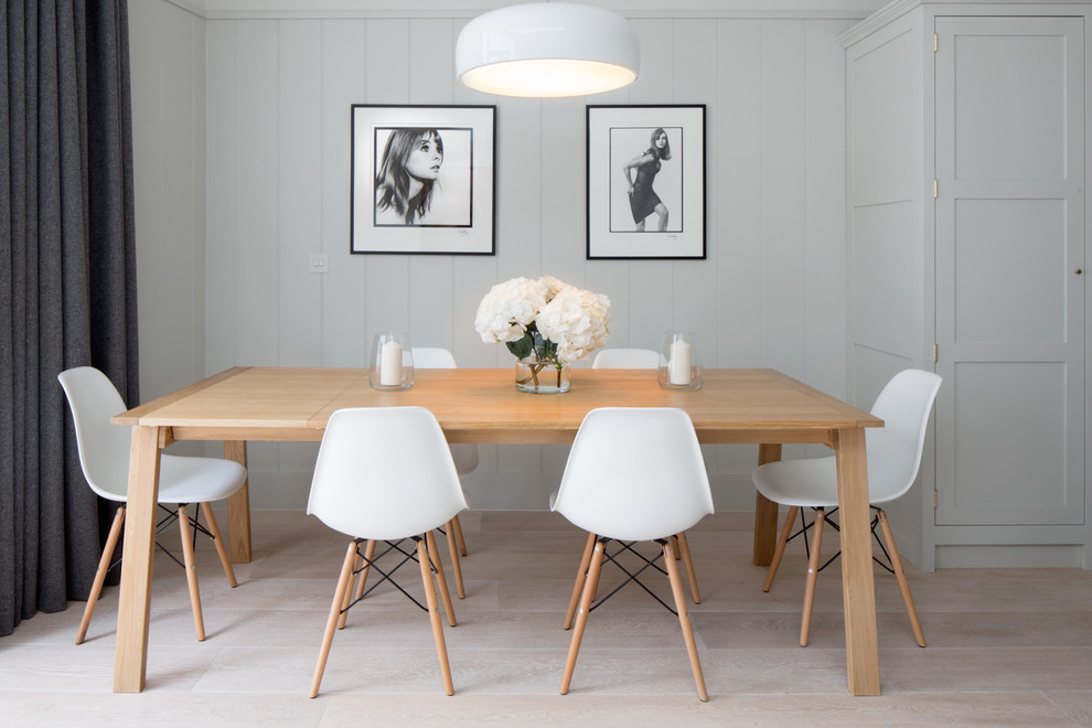 This is an example of a medium sized classic dining room in London with light hardwood flooring, white walls, no fireplace and beige floors.