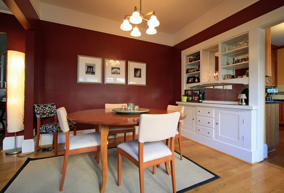 Photo of a medium sized traditional enclosed dining room in Portland with red walls and medium hardwood flooring.