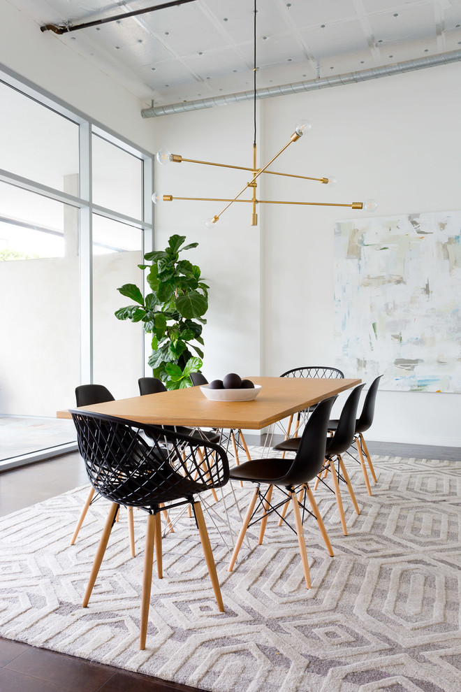 Example of a trendy brown floor dining room design in Los Angeles with white walls