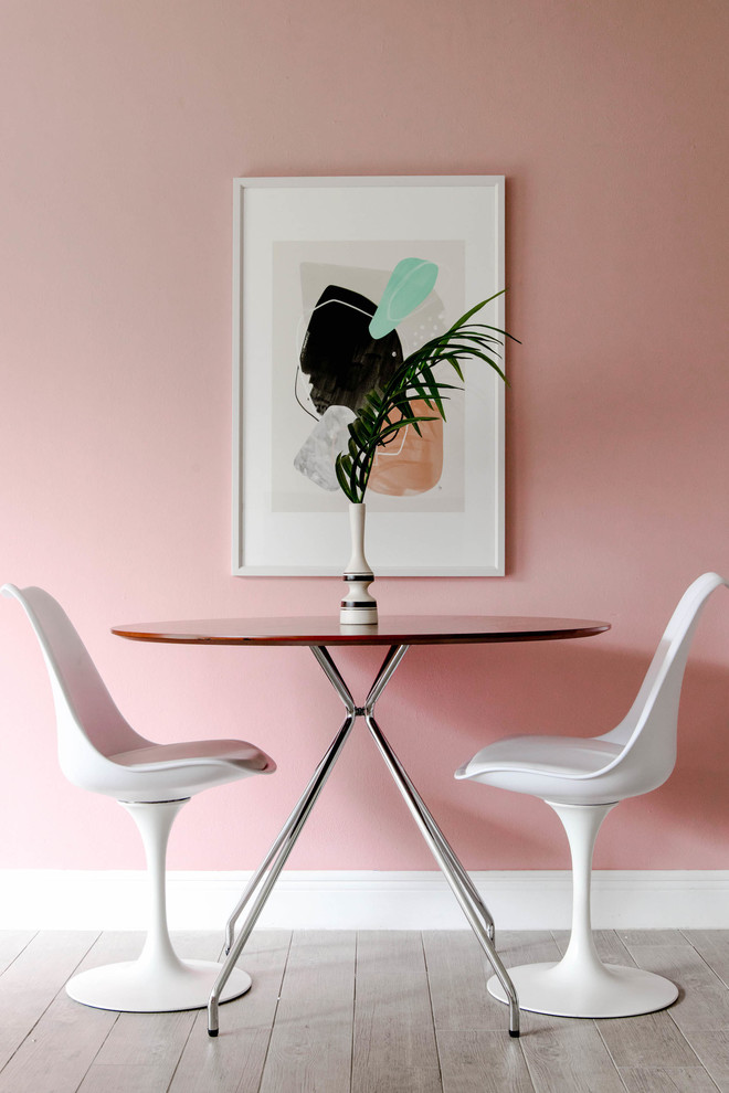 Foto di una piccola sala da pranzo minimalista con parquet chiaro, pareti rosa e nessun camino