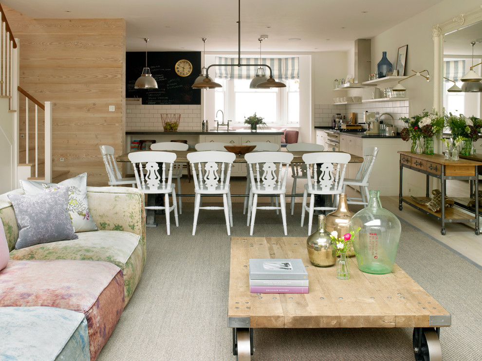 Example of a huge cottage chic light wood floor and beige floor kitchen/dining room combo design in London with beige walls and no fireplace