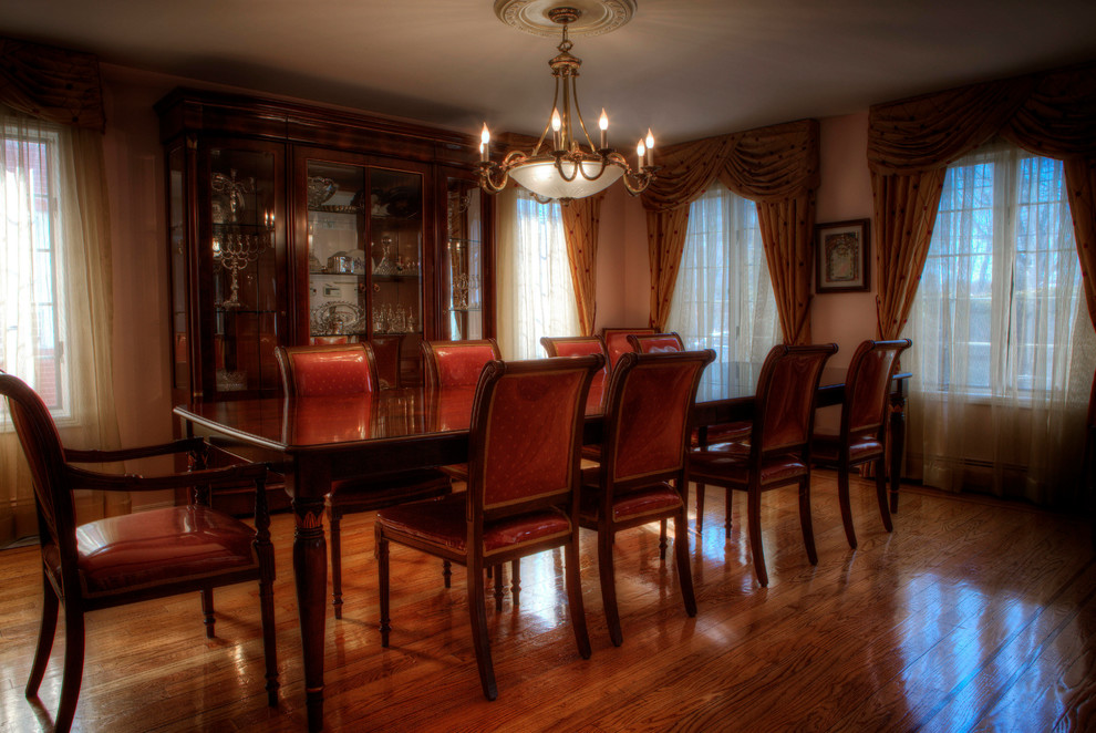 Medium sized victorian enclosed dining room in New York with beige walls, light hardwood flooring and no fireplace.