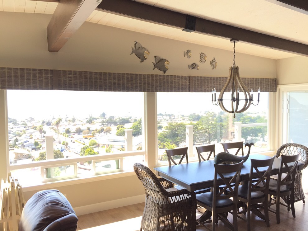 This is an example of a medium sized nautical enclosed dining room in San Luis Obispo with beige walls, light hardwood flooring, no fireplace and brown floors.