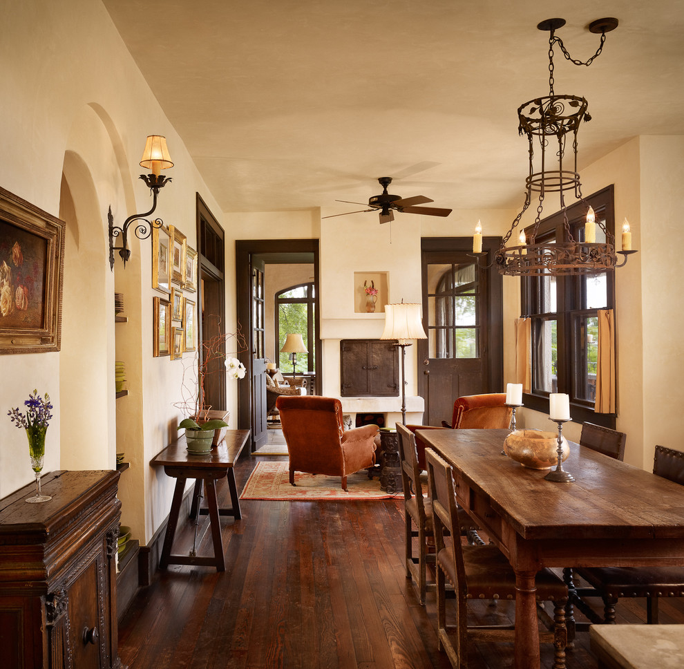 Inspiration for a mediterranean dark wood floor dining room remodel in Austin with beige walls