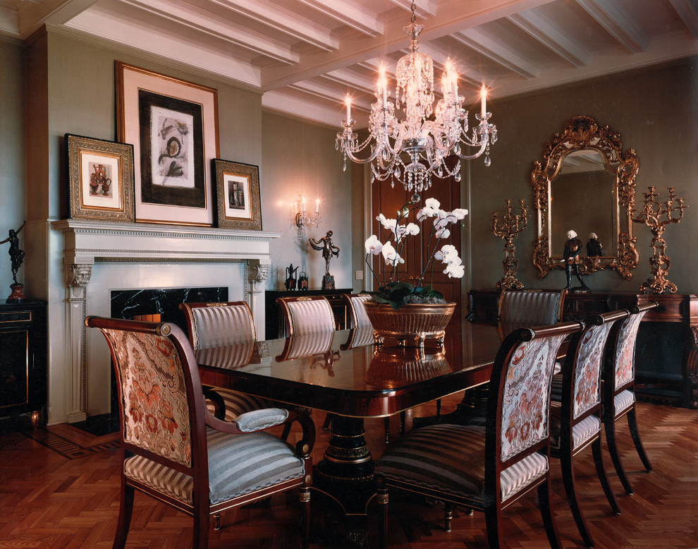 This is an example of a traditional dining room in Chicago with brown walls and dark hardwood flooring.