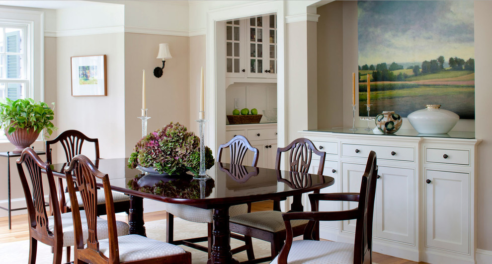 Mid-sized elegant medium tone wood floor enclosed dining room photo in Boston with beige walls