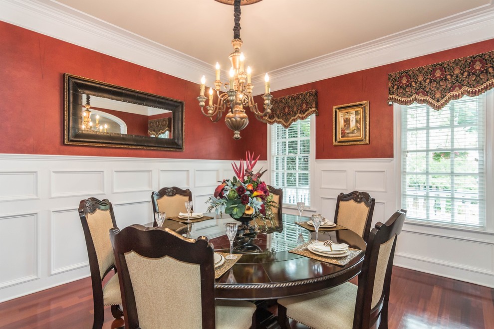 Photo of a classic dining room in Raleigh with dark hardwood flooring.