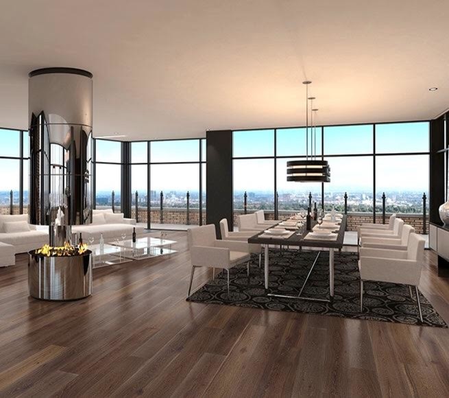 This is an example of a large contemporary enclosed dining room in Los Angeles with black walls, dark hardwood flooring, a hanging fireplace, a metal fireplace surround and brown floors.