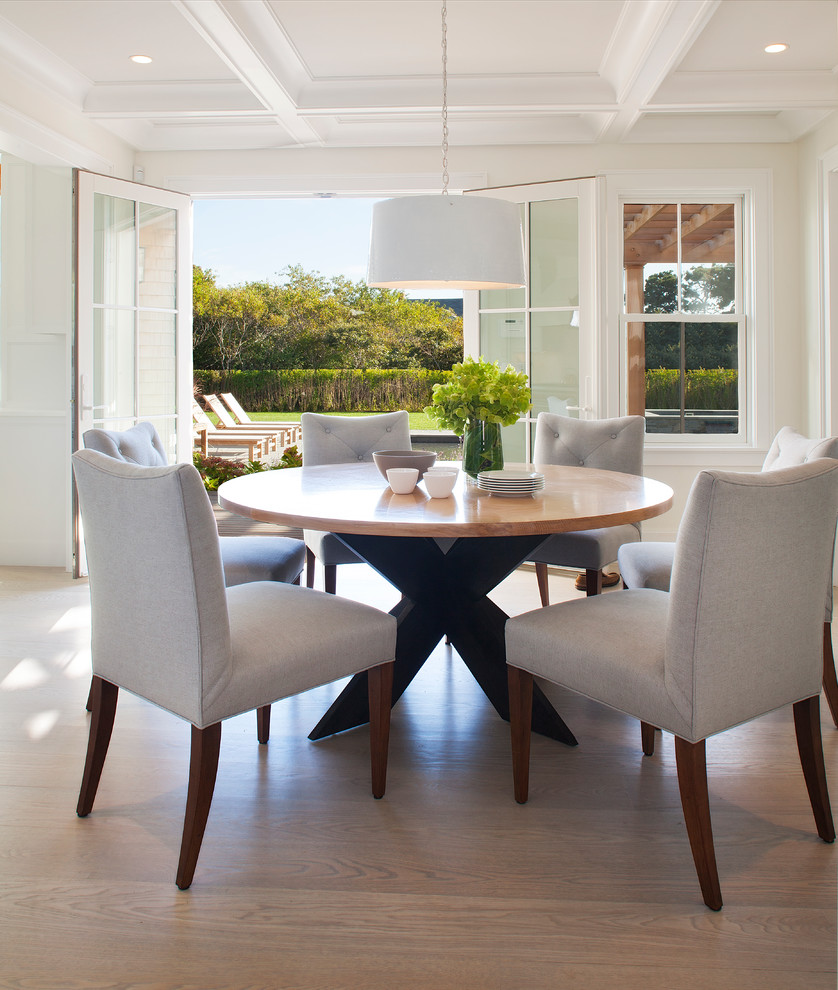 Cette image montre une salle à manger ouverte sur le salon minimaliste de taille moyenne avec un mur blanc, parquet clair et aucune cheminée.