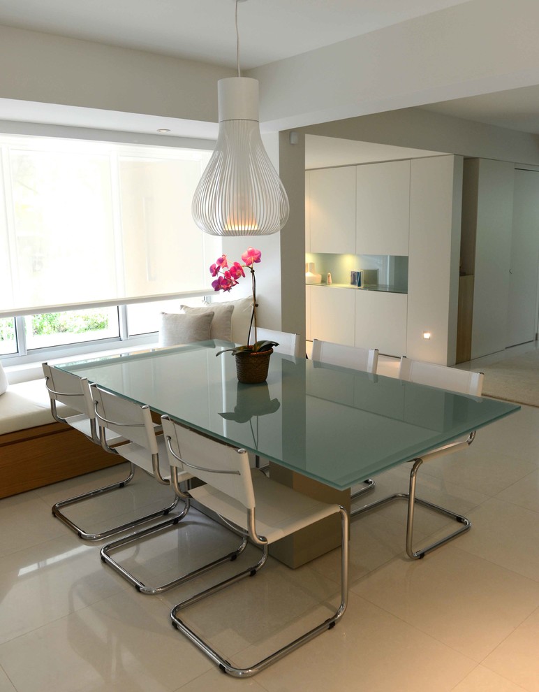 This is an example of a contemporary dining room in Miami with white walls.