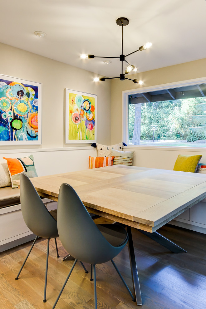 Photo of a medium sized contemporary enclosed dining room in Seattle with beige walls and medium hardwood flooring.