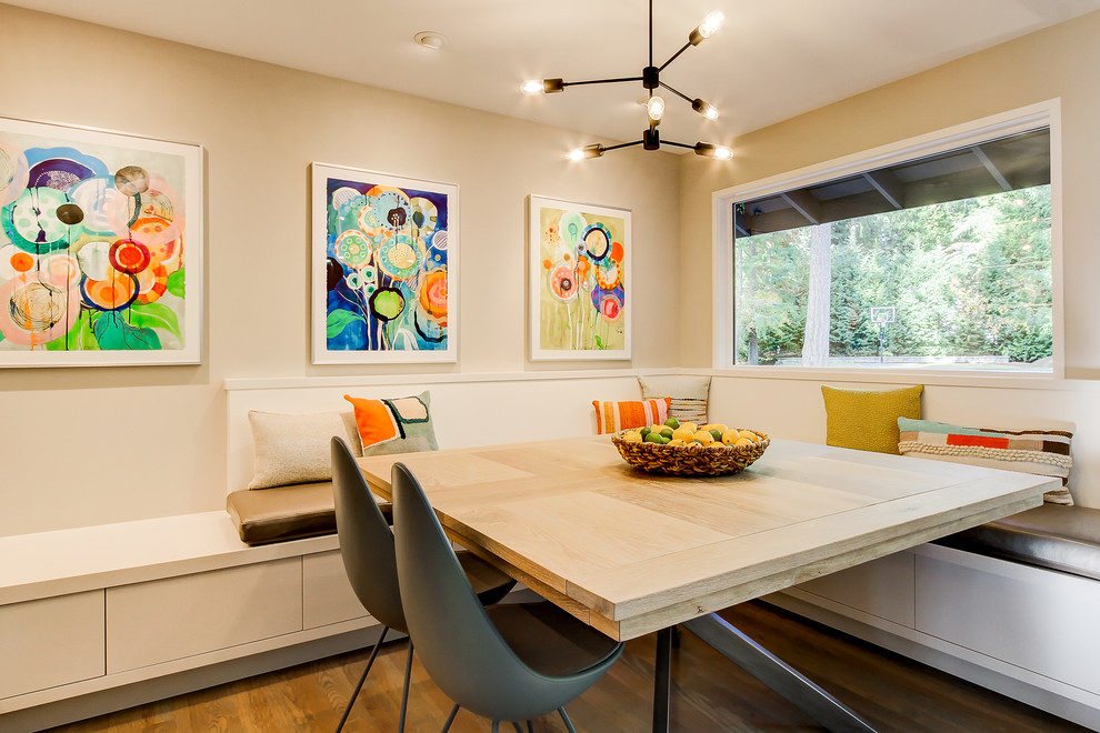 Example of a mid-sized trendy medium tone wood floor enclosed dining room design in Seattle with beige walls