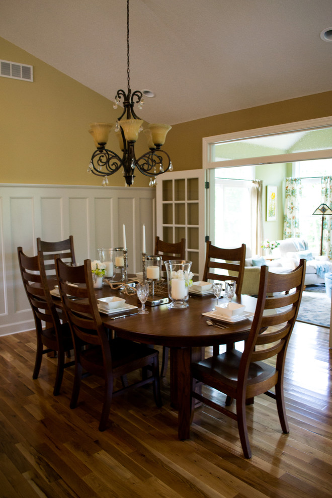 Réalisation d'une grande salle à manger ouverte sur la cuisine tradition avec un mur beige et parquet clair.