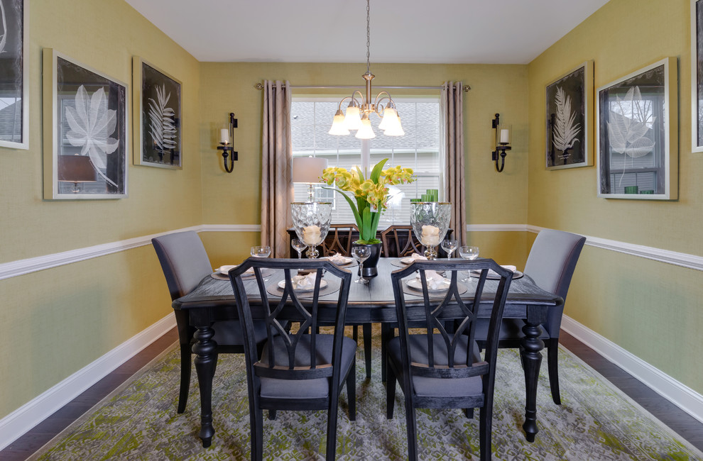 Inspiration for a mid-sized transitional dark wood floor and brown floor enclosed dining room remodel in Philadelphia with yellow walls