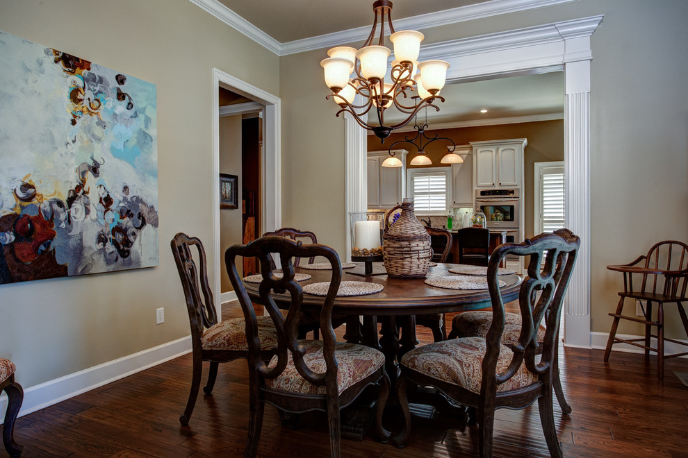 Example of a mid-sized classic dark wood floor and brown floor enclosed dining room design in Little Rock with beige walls
