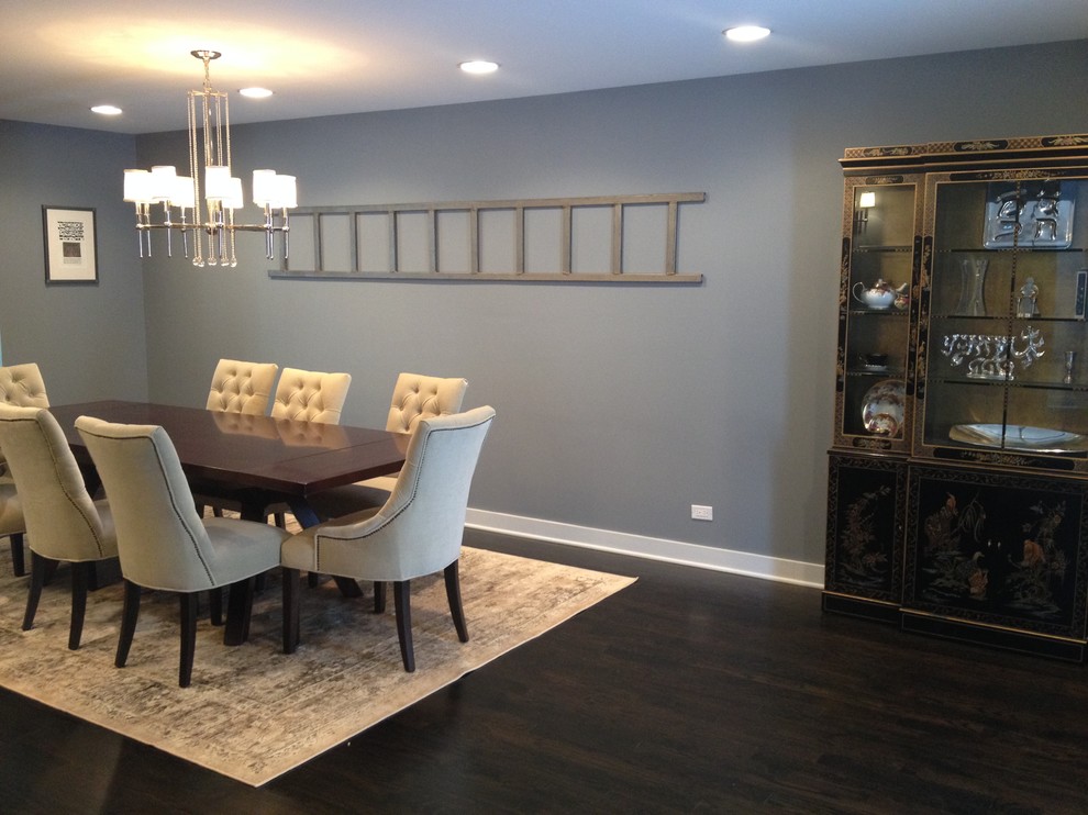 This is an example of a large eclectic enclosed dining room in Chicago with grey walls and dark hardwood flooring.