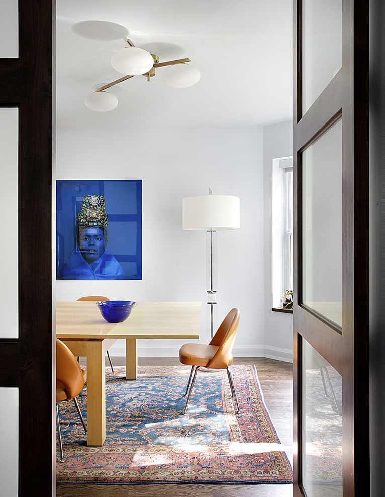 Example of a 1950s dark wood floor dining room design in Chicago with white walls