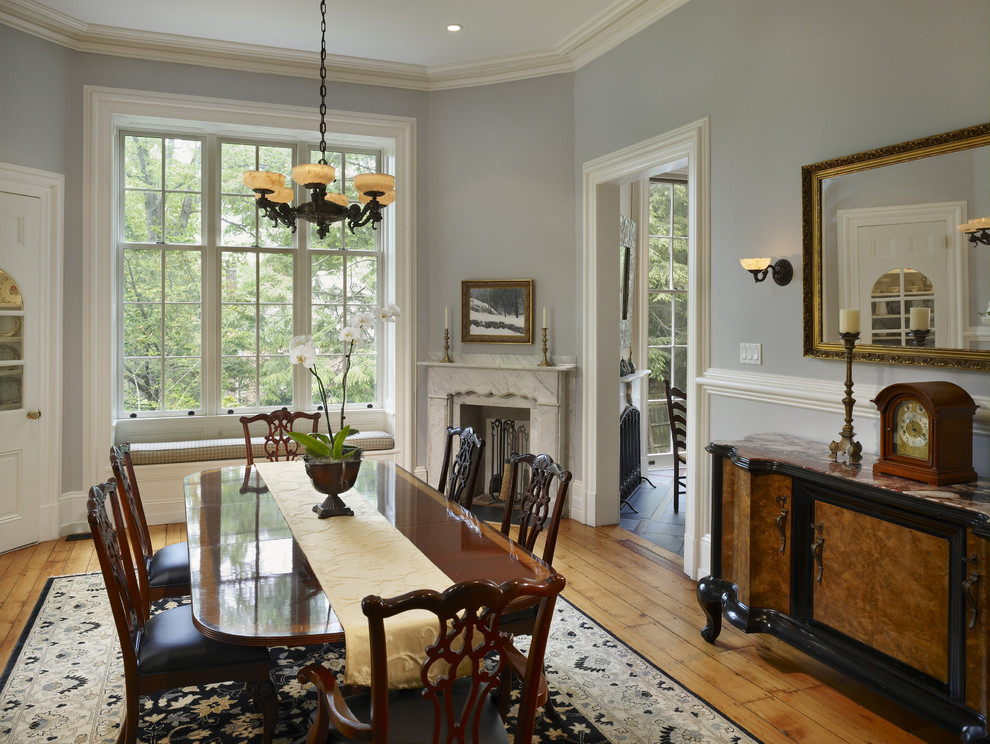 Dining room - traditional dining room idea in Philadelphia with a corner fireplace and gray walls