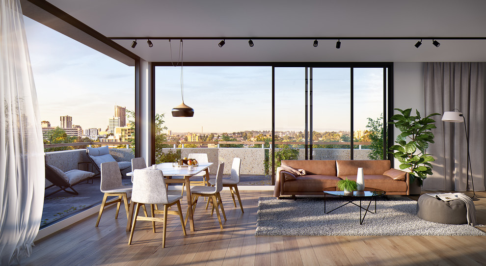 Modelo de comedor contemporáneo abierto con paredes blancas, suelo de madera clara y suelo beige