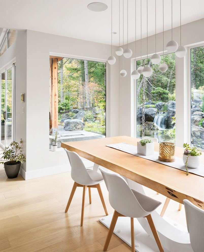 This is an example of a medium sized contemporary open plan dining room in Vancouver with grey walls, light hardwood flooring and beige floors.