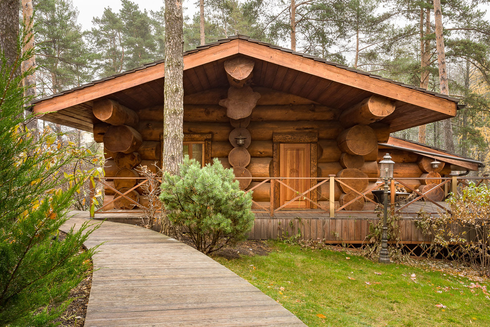 Photo of a medium sized and beige rustic bungalow house exterior in Moscow with wood cladding and a pitched roof.