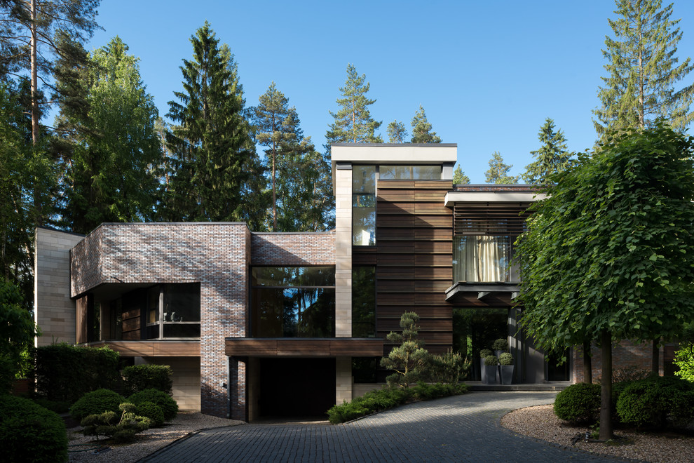 Diseño de fachada de casa actual con revestimiento de ladrillo y tejado plano