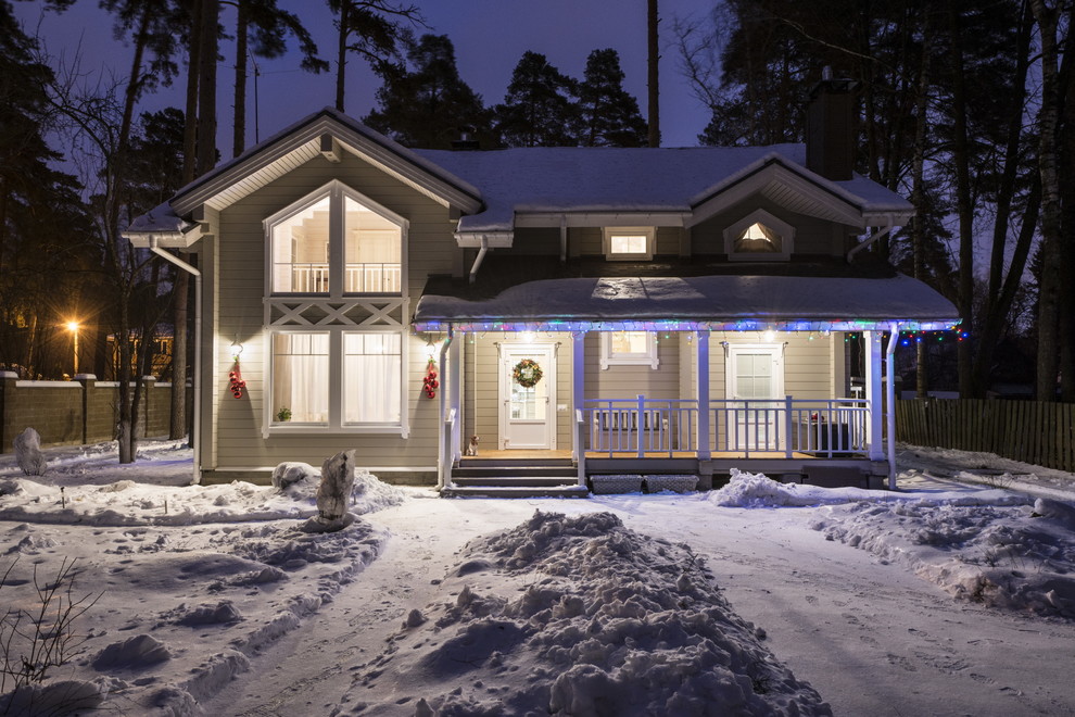 Design ideas for a small classic two floor house exterior in Moscow with wood cladding.