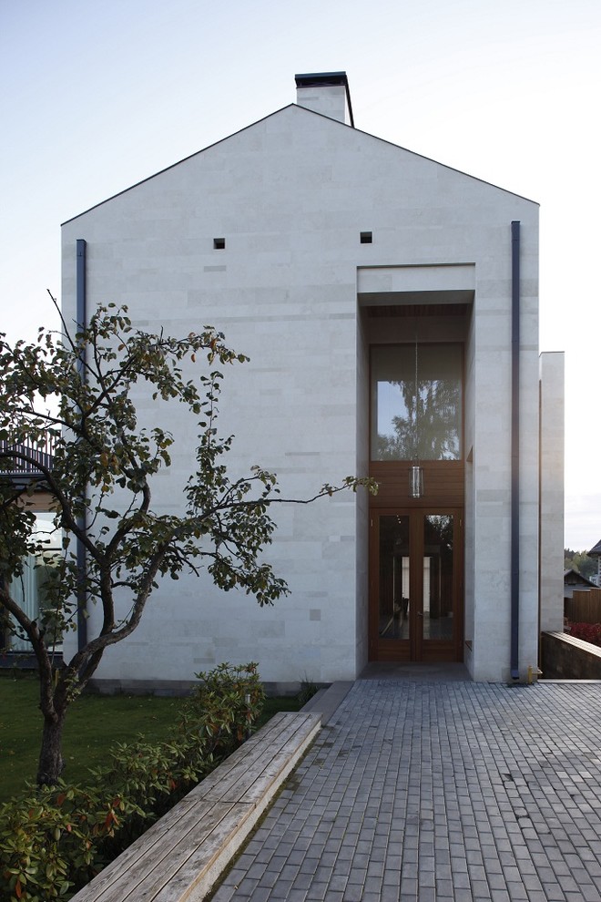 Идея дизайна: двухэтажный, серый дом в современном стиле с облицовкой из бетона и двускатной крышей