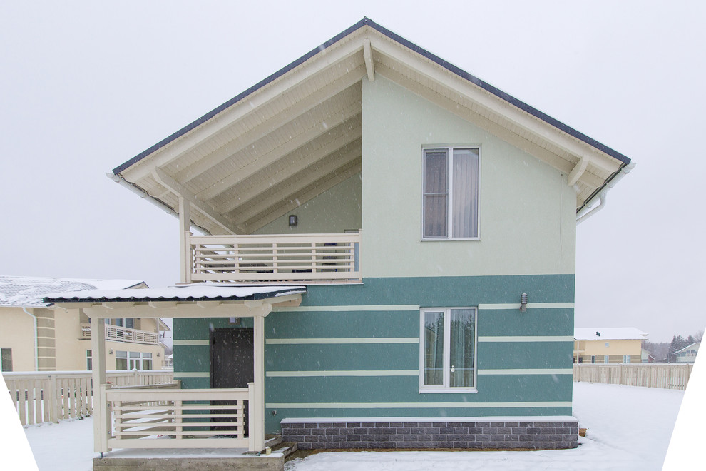 Photo of a medium sized and blue classic two floor render house exterior in Saint Petersburg with a lean-to roof.
