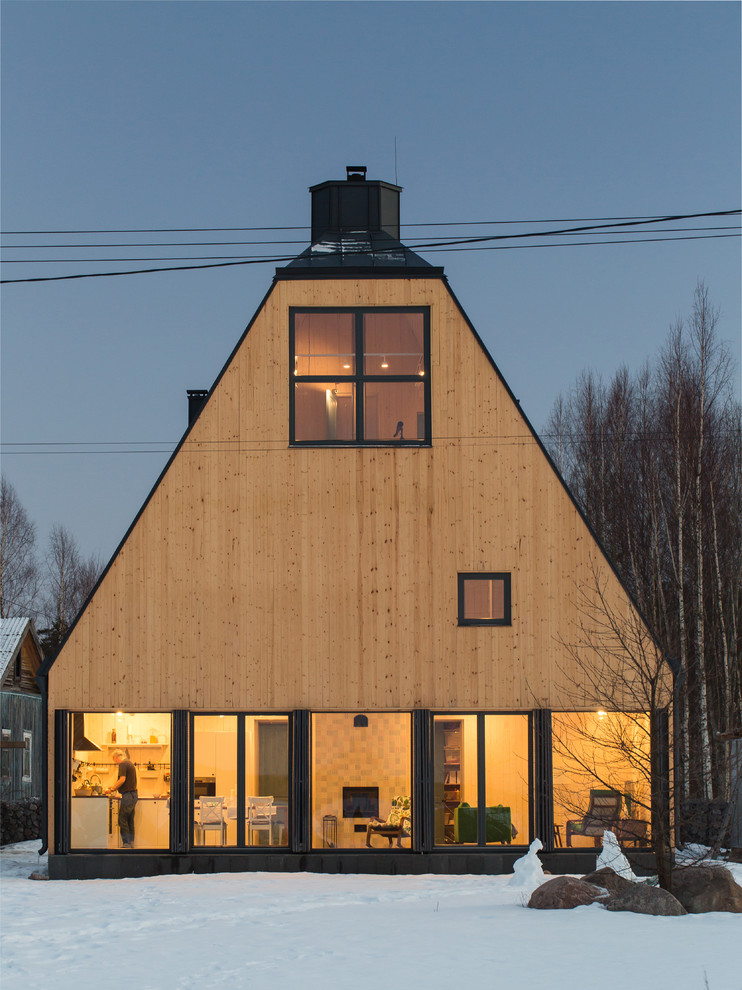 Пример оригинального дизайна: трехэтажный, деревянный, желтый частный загородный дом среднего размера в стиле рустика с мансардной крышей и металлической крышей