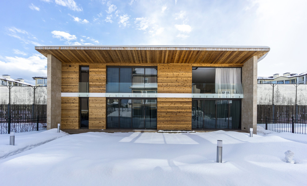 Brown contemporary two floor house exterior in Moscow with wood cladding and a flat roof.