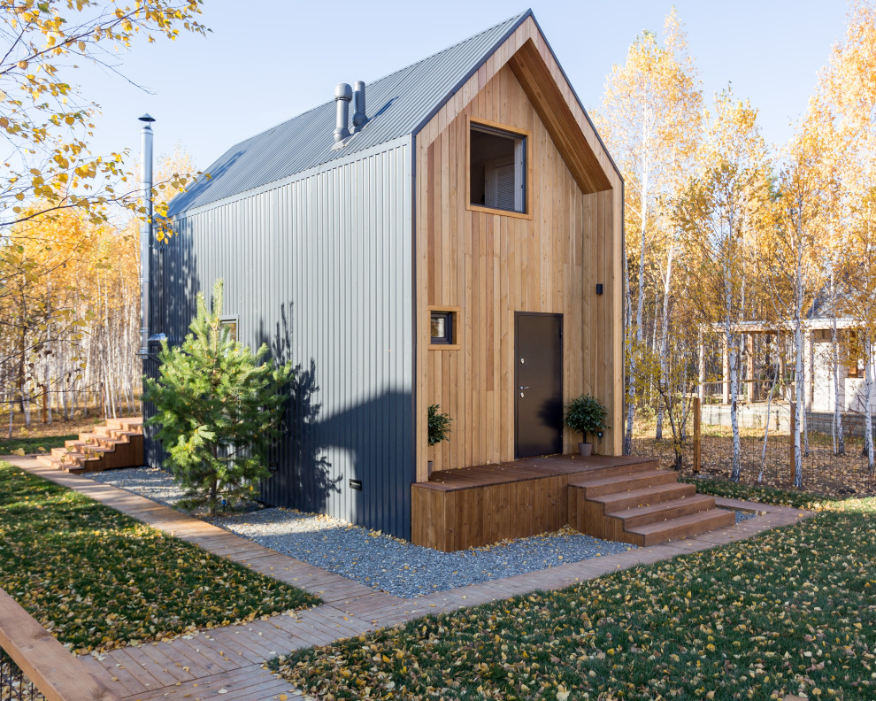 Design ideas for a small and brown scandinavian two floor detached house in Other with wood cladding, a pitched roof and a metal roof.