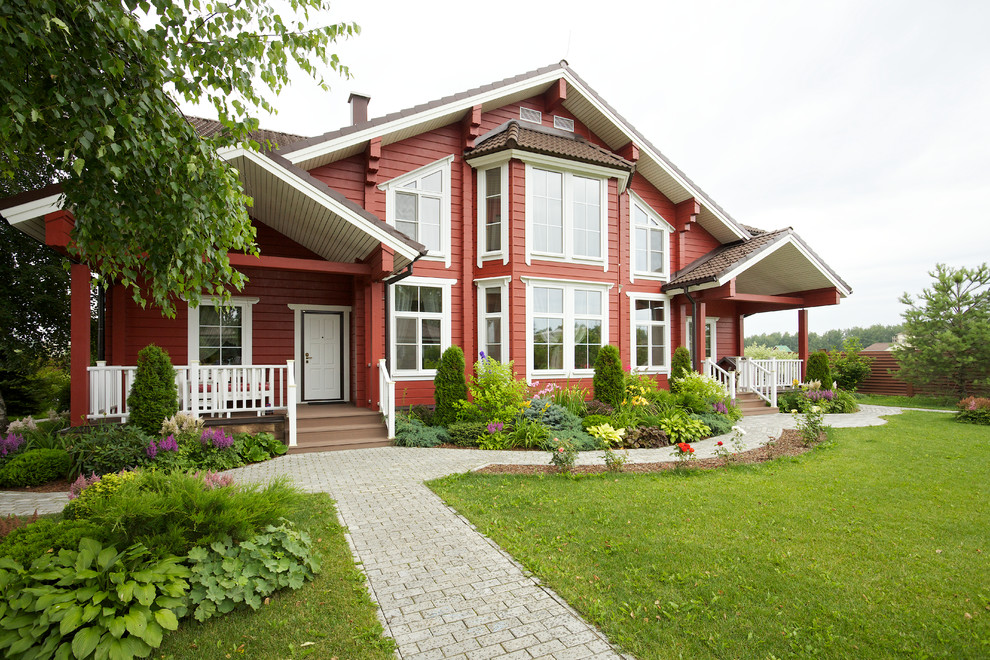 На фото: двухэтажный, деревянный, красный частный загородный дом в классическом стиле с двускатной крышей и черепичной крышей