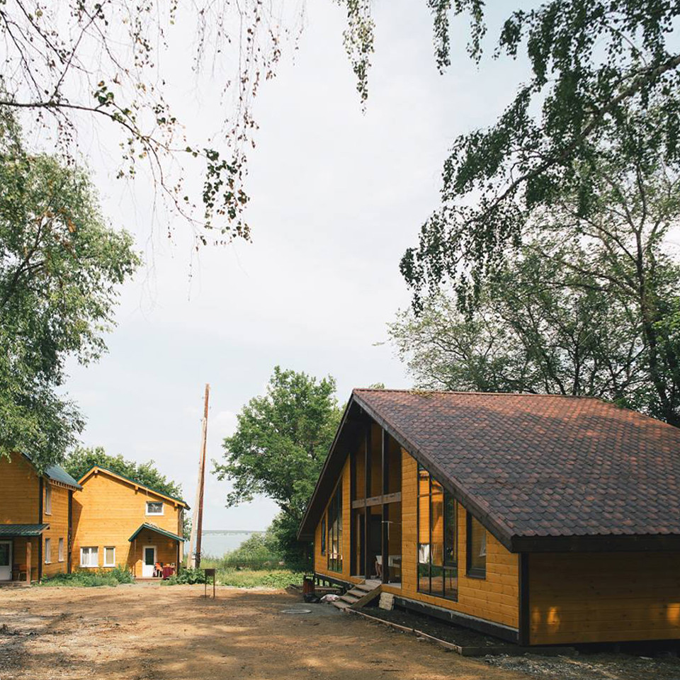 Kleines Skandinavisches Haus mit brauner Fassadenfarbe, Satteldach und Blechdach in Sonstige