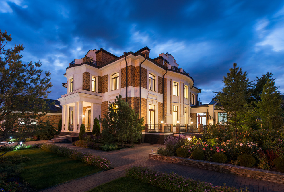 Imagen de fachada de casa multicolor tradicional grande de tres plantas con revestimientos combinados y tejado de metal