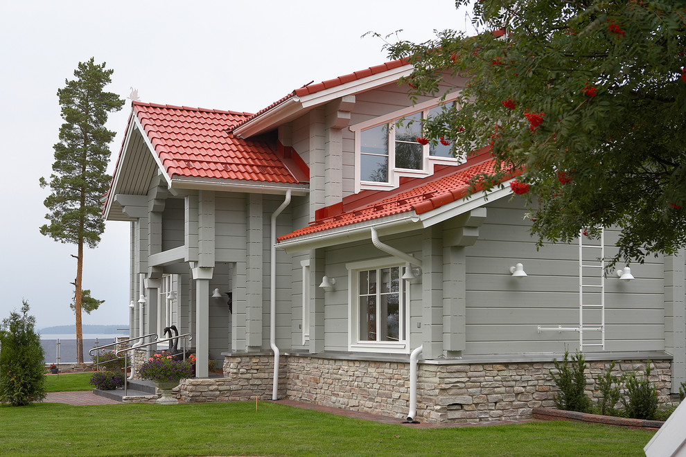 Пример оригинального дизайна: деревянный, серый частный загородный дом в современном стиле с двускатной крышей