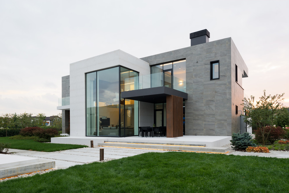 Medium sized and multi-coloured contemporary two floor house exterior in Moscow with mixed cladding and a flat roof.