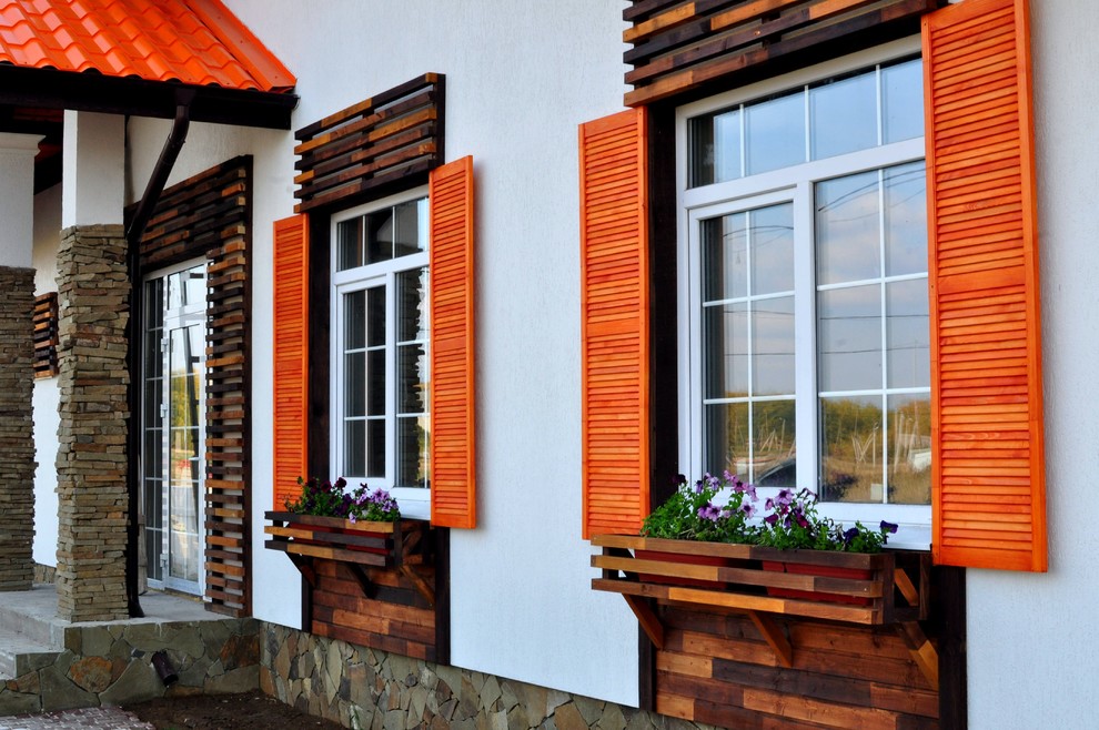 Mittelgroßes, Einstöckiges Skandinavisches Einfamilienhaus mit Mix-Fassade, weißer Fassadenfarbe, Walmdach und Blechdach in Sonstige