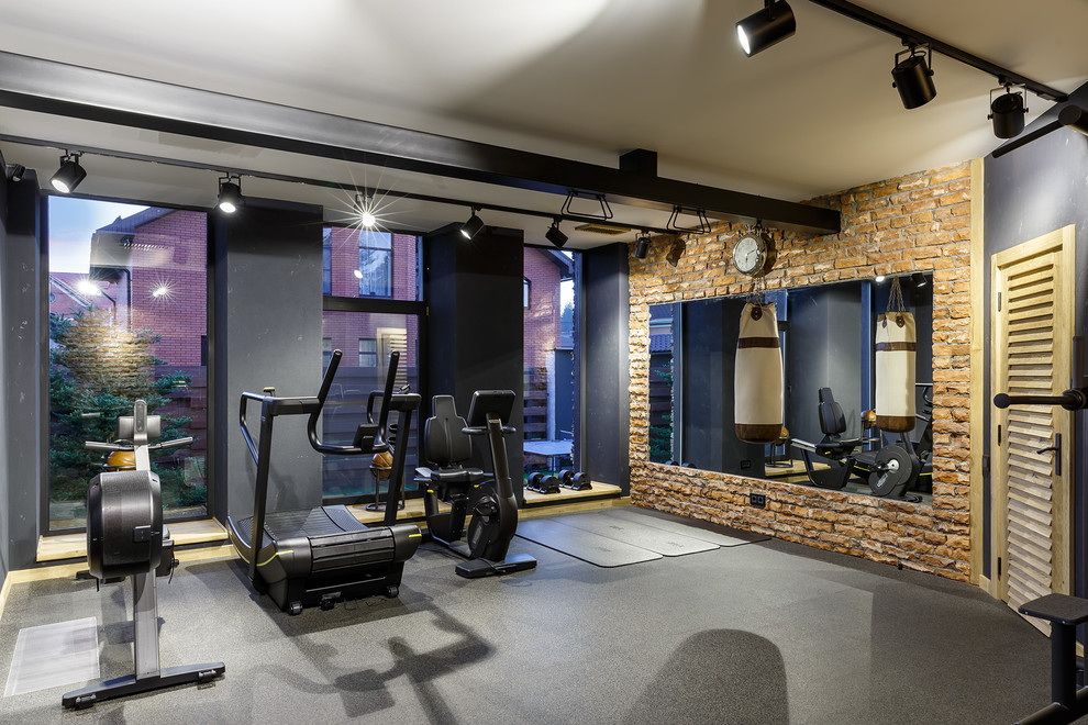 Urban home weight room in Saint Petersburg with grey floors and a feature wall.