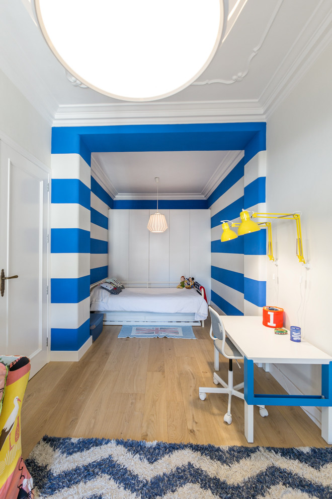 Immagine di una cameretta per bambini da 4 a 10 anni contemporanea di medie dimensioni con pareti multicolore e parquet chiaro