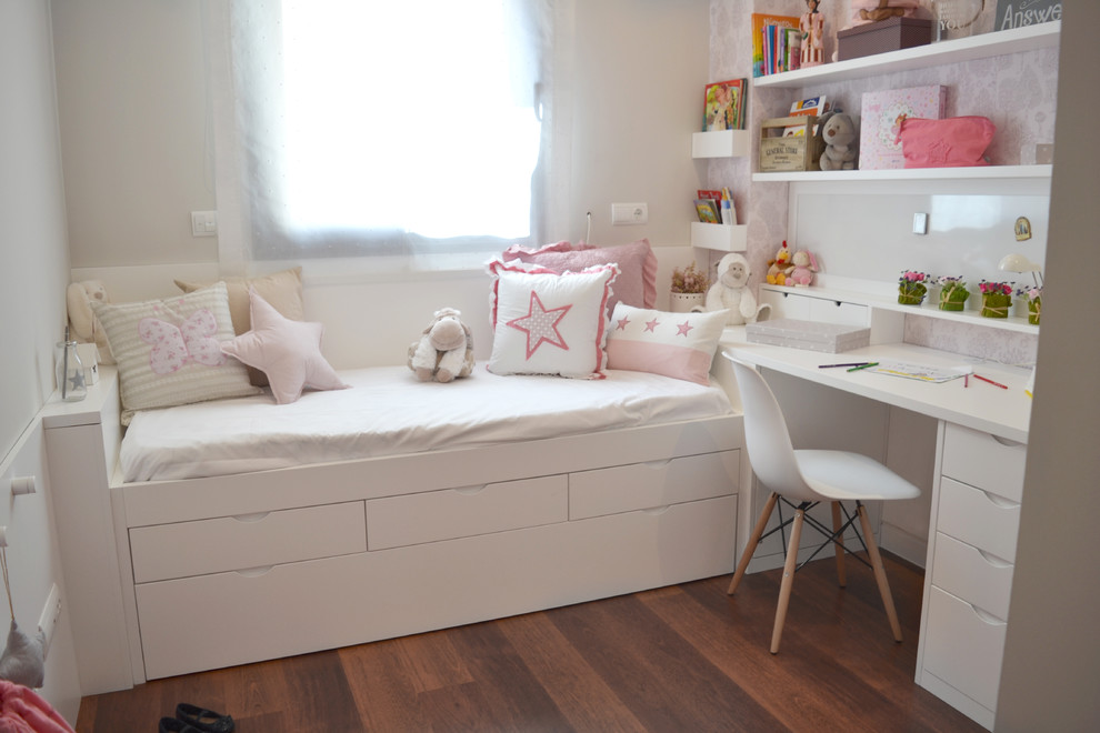 Mid-sized transitional girl medium tone wood floor and brown floor kids' room photo in Madrid with beige walls