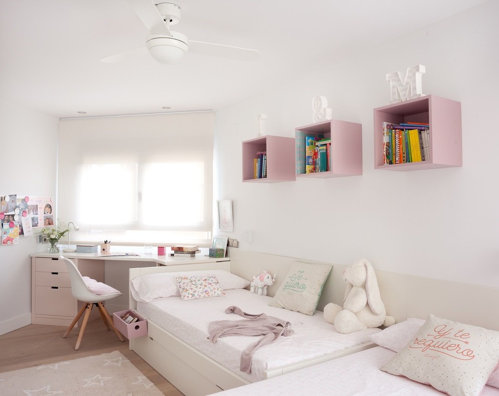 Inspiration for a medium sized vintage children’s room for girls in Madrid with white walls.