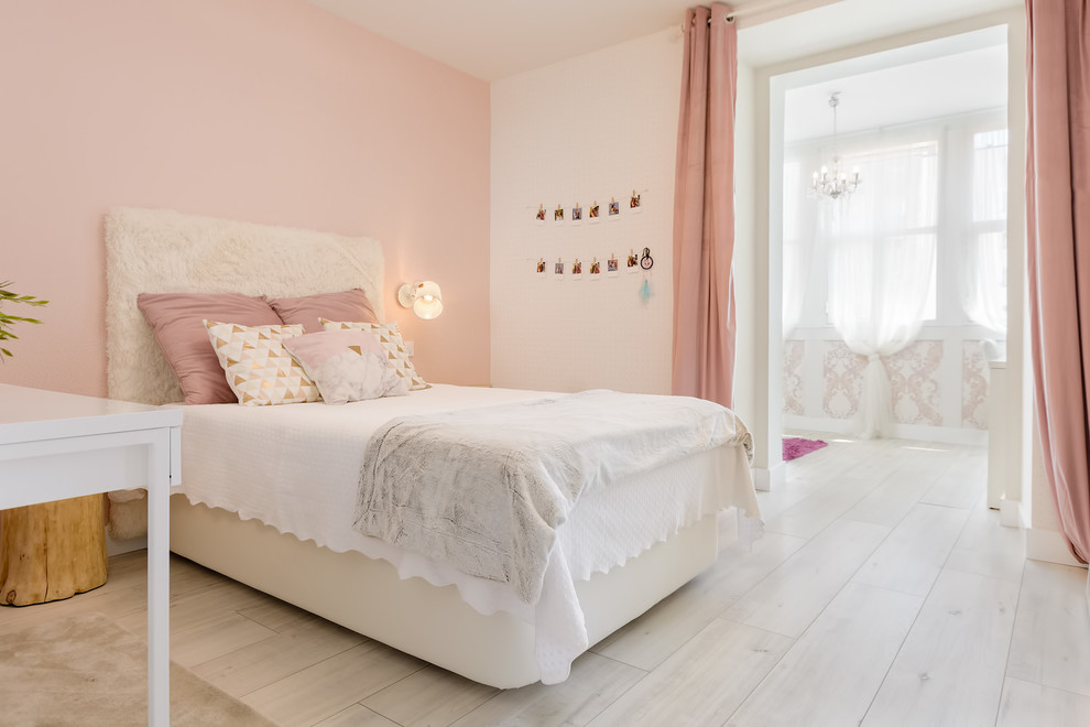 This is an example of a medium sized vintage teen’s room for girls in Other with pink walls, light hardwood flooring and grey floors.