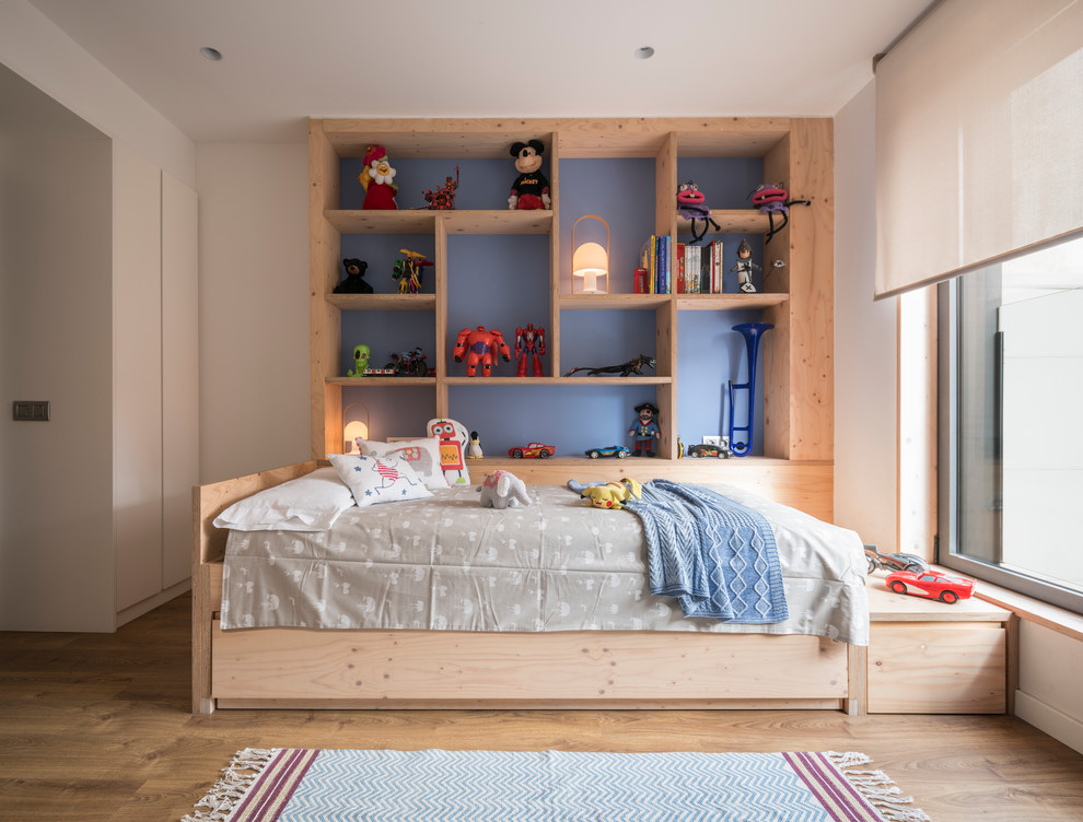 Mid-sized trendy gender-neutral medium tone wood floor and brown floor kids' room photo in Barcelona with blue walls