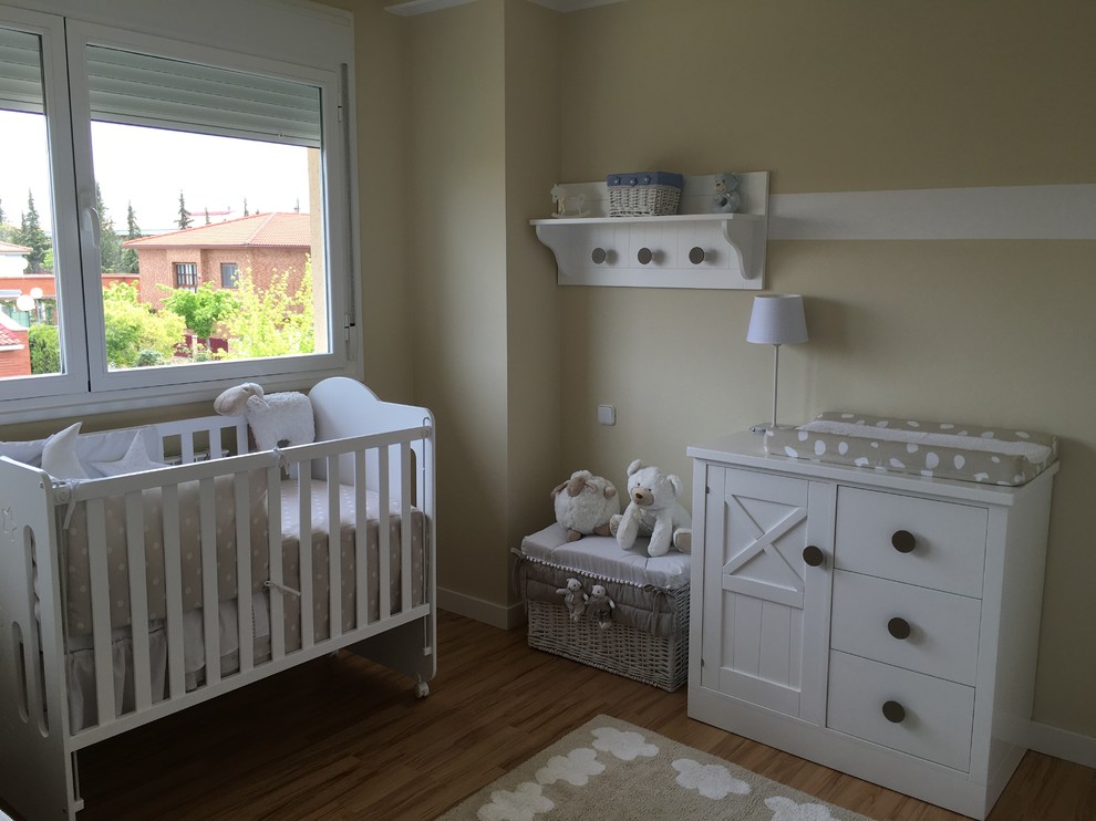 Photo of a medium sized scandi gender neutral nursery in Other with beige walls and medium hardwood flooring.