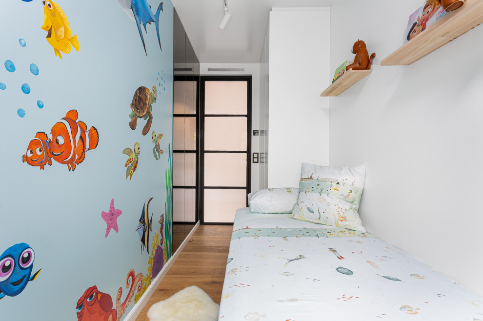 Small ornate boy medium tone wood floor and wallpaper kids' room photo in Barcelona with white walls