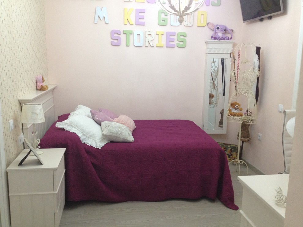 Inspiration for a medium sized classic children’s room for girls in Other with pink walls.