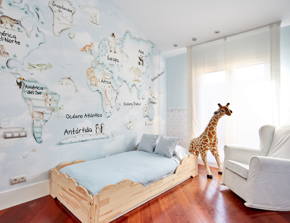 Example of a mid-sized transitional boy medium tone wood floor kids' room design in Madrid with blue walls